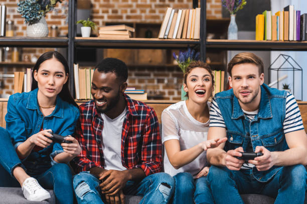 istock happy young multiethnic friends playing with gamepads together at home 928294580