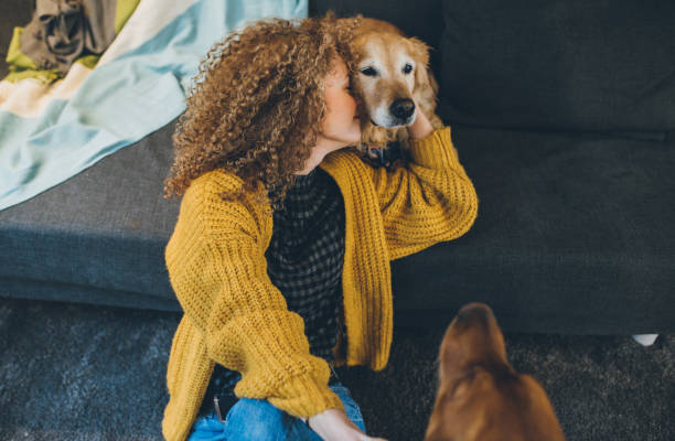 istock Woman playing with her dogs 928299438