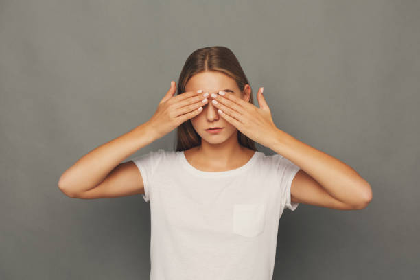 istock Scared woman covering eyes with hands, see no evil 928300512