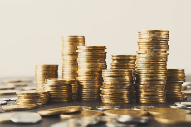 istock Increasing columns of gold coins on table 928306528