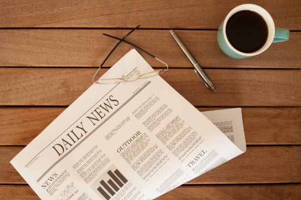 istock newspaper over wooden table 928312742