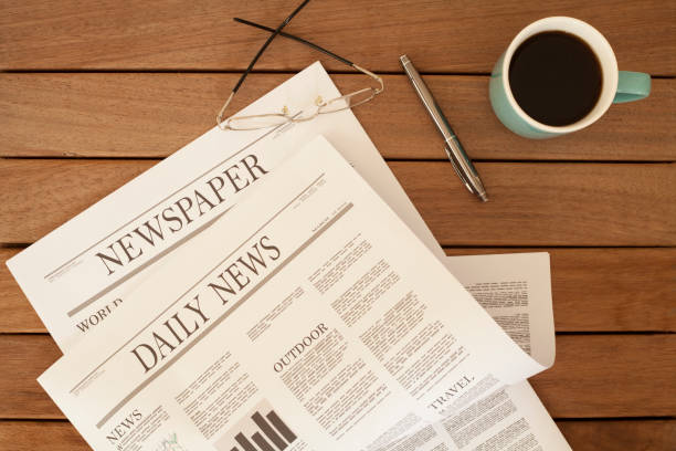istock newspaper over wooden table 928312910