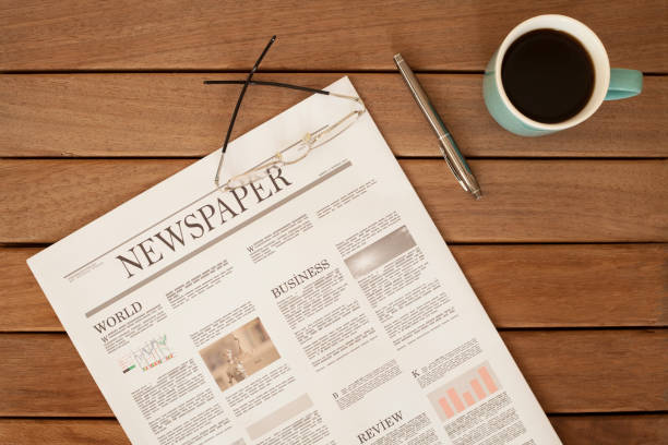istock newspaper over wooden table 928313296