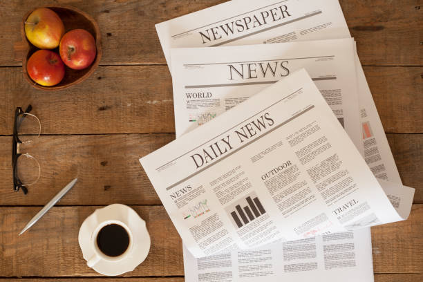 istock newspaper over wooden table 928313516