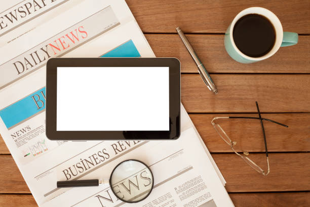 istock newspaper over wooden table 928314088