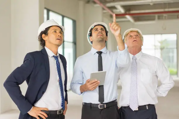 Photo of Controller Inspecting Pipes in New Building