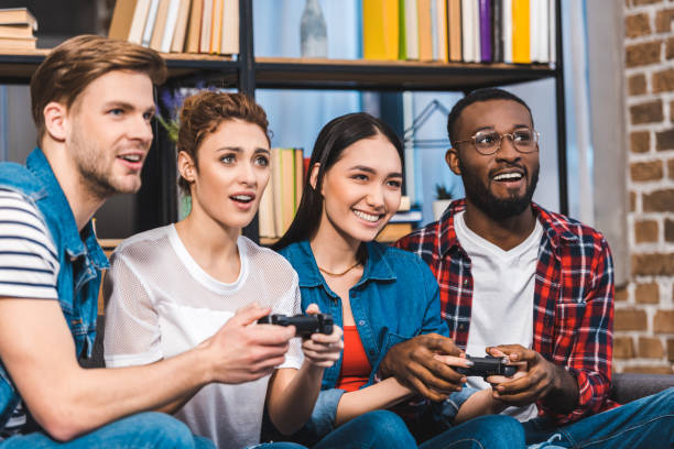 istock young multiethnic friends playing with joysticks together at home 928314908