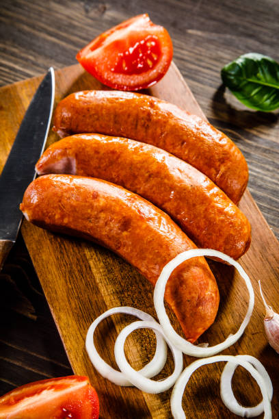 istock Raw sausages on cutting board 928317346