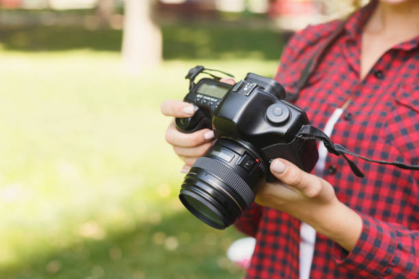 istock Woman taking photos while standing in the park 928317358