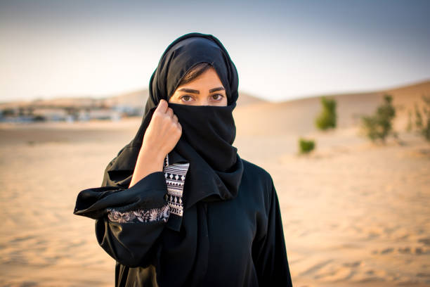 Portrait of beautiful Muslim woman wearing traditional Arabian clothing in the desert. Portrait of beautiful Muslim woman wearing traditional Arabian clothing in the desert. bedouin photos stock pictures, royalty-free photos & images