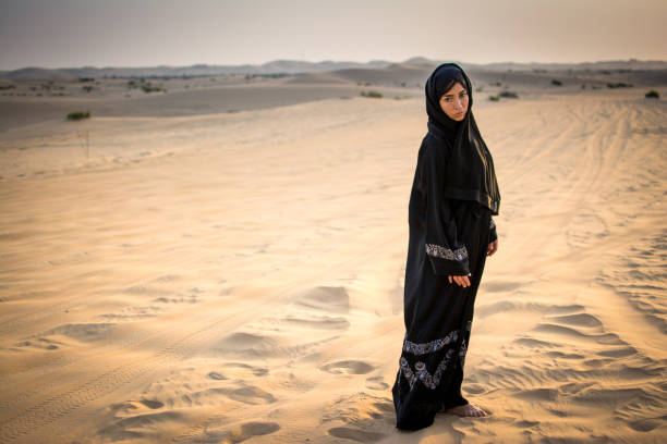 istock Arab woman standing in the desert. 928319552
