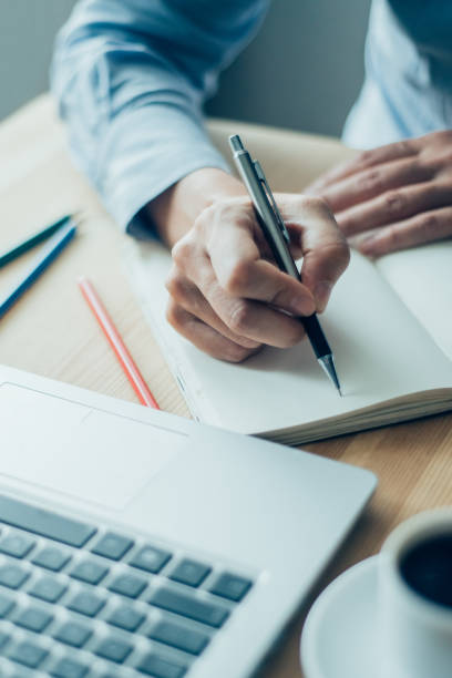 istock Closeup of Employee Making Notes in Office 928319962