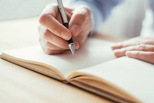 istock Closeup of Person Making Notes at Table 928320038