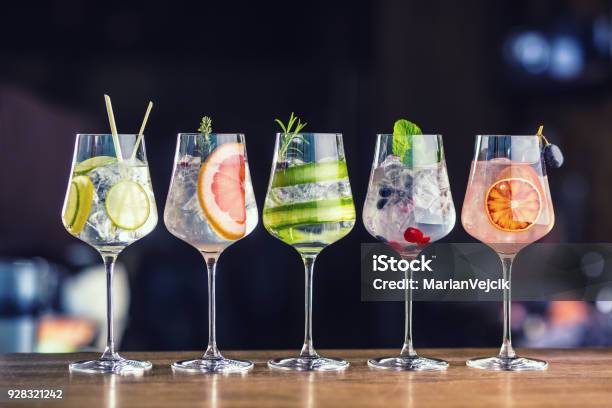 Five Colorful Gin Tonic Cocktails In Wine Glasses On Bar Counter In Pup Or Restaurant Stock Photo - Download Image Now
