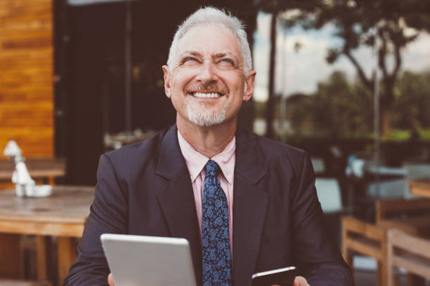 istock Dreamy Boss Using Tablet and Smartphone Outdoors 928324150