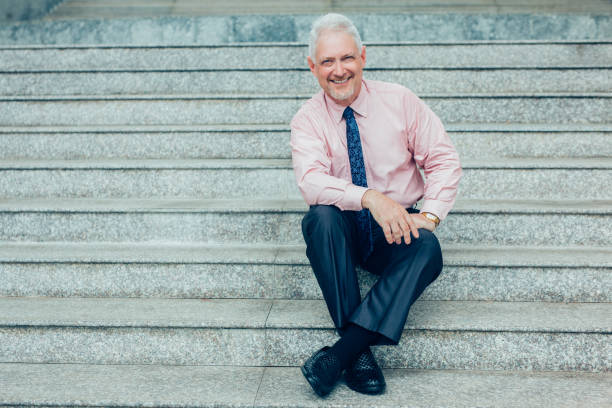 istock Relaxed Entrepreneur Sitting on Stairs Outdoors 928324270