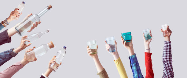 istock Different people holding water bottles and glass 928324990