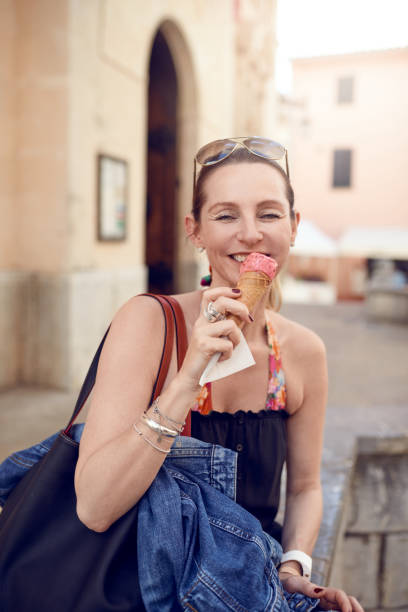 istock Smiling attractive woman enjoying an ice cream 928331406