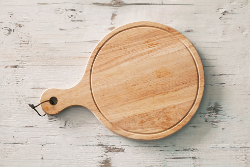 Wooden chopping board on wooden background
