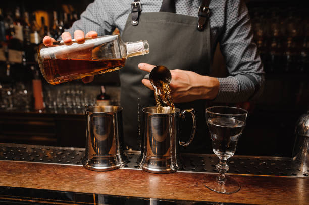 istock Barman in apron making and alcoholic cocktail 928331700