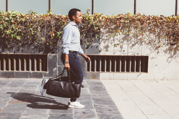 istock Hispanic Young Man with Leather Bag Running 928334190