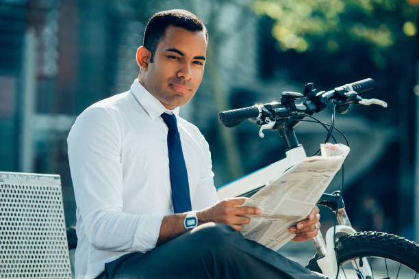istock Smiling Latin Businessman with Newspaper in Park 928334202