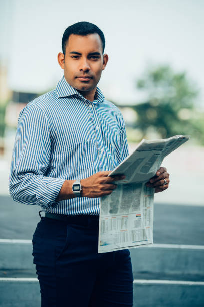 istock Portrait of Confident Hispanic Man with Newspaper 928334228