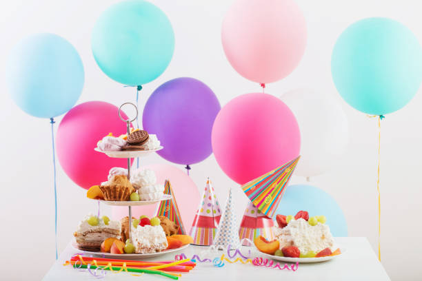 istock Birthday celebration with cake and colorful balloons 928334794