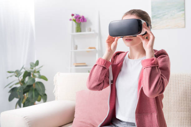 istock girl wearing virtual reality headset at home 928336626