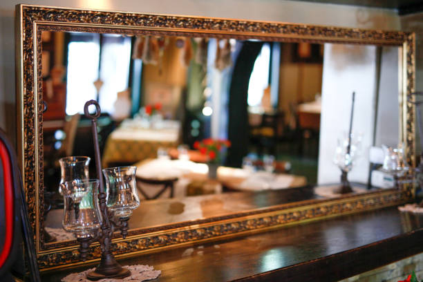 Reflection in golden mirror of restaurant interior