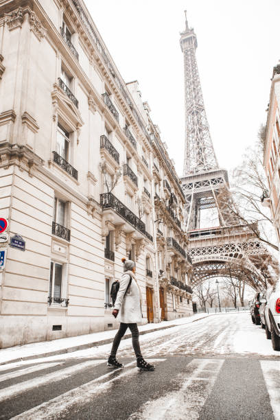 istock Woman walking to the Eiffel tower with snow 928337706