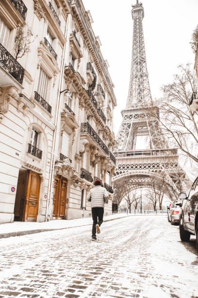 istock Man running to the Eiffel tower with snow 928338050