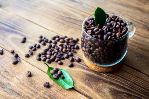 istock cup of coffe beans and green leaf 928342634