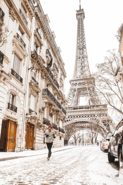 istock Man running to the Eiffel tower with snow 928344288