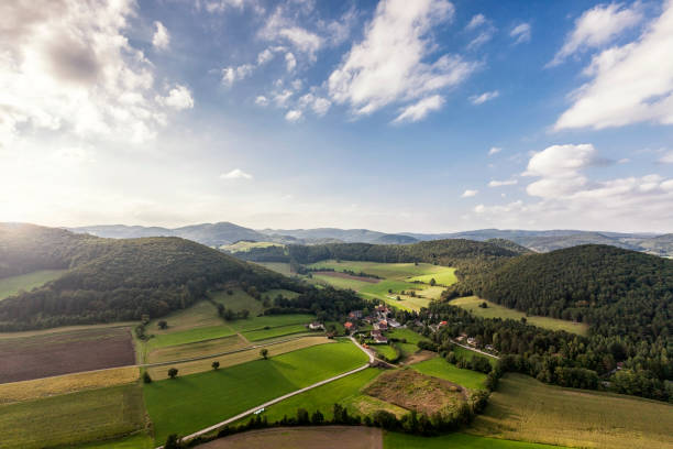Landscape of the Vienna Woods in Lower Austria with little village Untermeierhof Aerial Shot of picturesque landscape of the Vienna Woods in Lower Austria with little village Untermeierhof vienna woods stock pictures, royalty-free photos & images