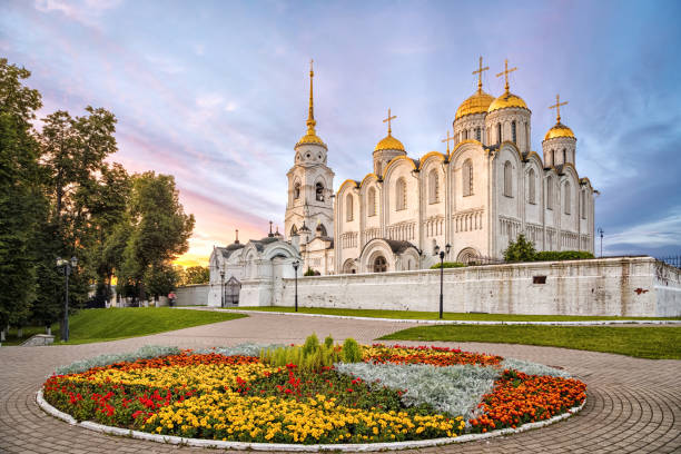 Uspenskiy cathedral on sunset in Vladimir, Russia Uspenskiy cathedral on sunset with flowerbed on foreground in Vladimir, Russia vladimir russia photos stock pictures, royalty-free photos & images