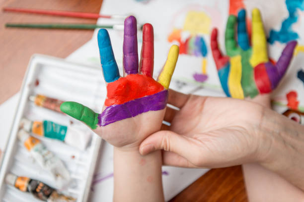 istock Girl hands in paint 928358432