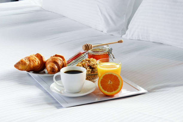istock Breakfast in bed in hotel room. 928359334