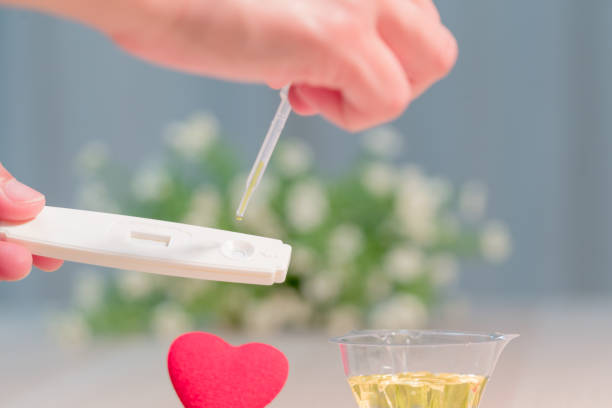 istock soft focus on the prenancy test process with red heart shape 928360394