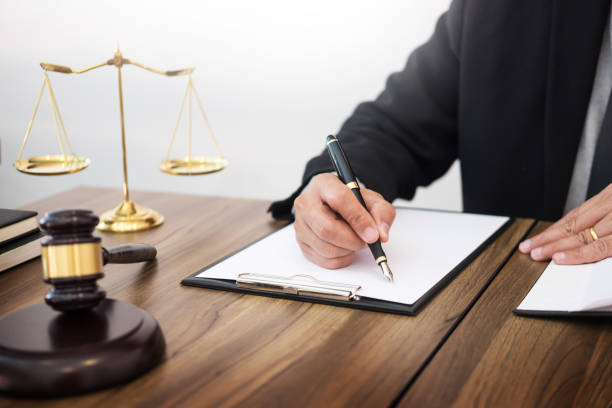 istock Midsection Of Judge Signing Document 928363598