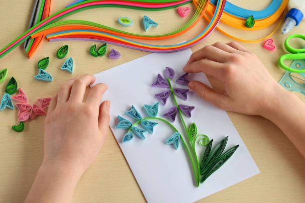 istock Quilling technique. Making decorations or greeting card. Paper strips, flower, scissors. Handmade crafts on holiday: Birthday, Mother's or Father's Day, March 8, Wedding. Children's DIY concept. 928364608