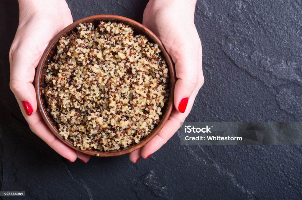 Healthy cooked quinoa Healthy cooked quinoa in woman hand . Superfood background Ancient Stock Photo