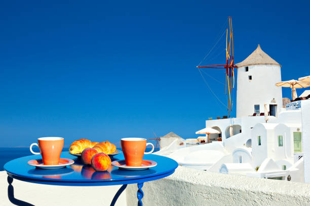 Breakfast on the terrace on the background of the classic Santorini view.