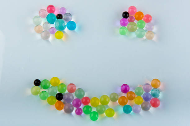 istock orbeez hydrogel balls laying in smile shape on white background 928369318