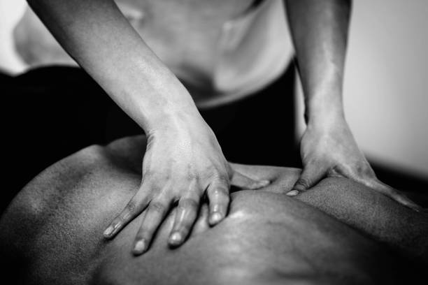 istock Woman Massaging Man Lying On Bed 928370286