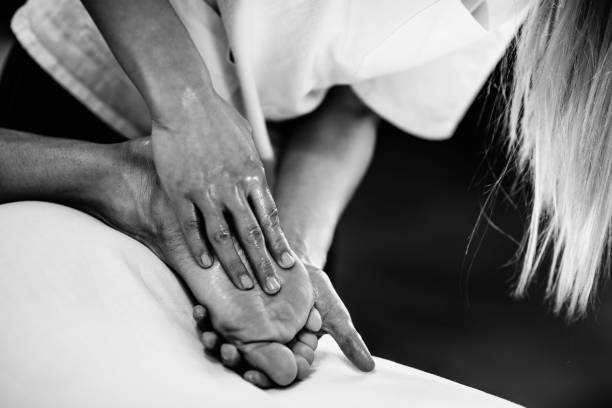 istock Woman Massaging Man Lying On Bed 928372400