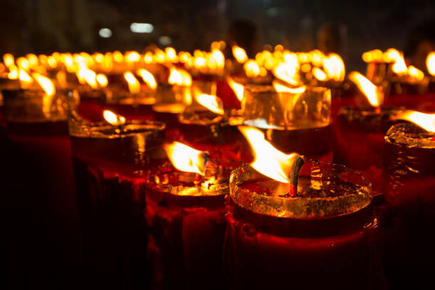 istock candle in the row at night time with bright flame 928375320