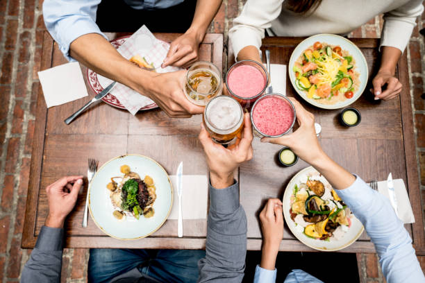 istock Close-up on people making a toast at a restaurant 928375358