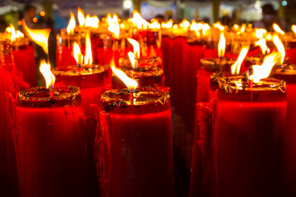 istock candle in the row at night time with bright flame 928375490