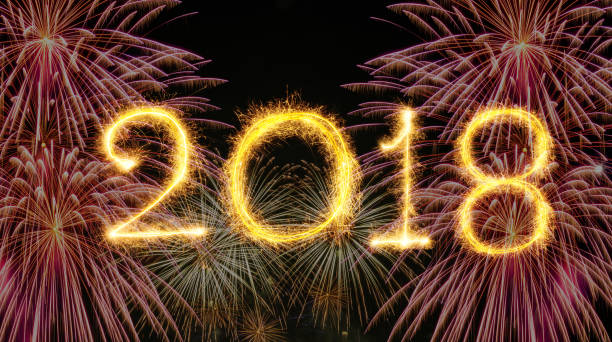 istock 2018 written with Sparkle firework on fireworks with dark background, Happy new year celebration and greeting cards concept 928377206